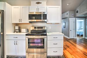 a kitchen with white cabinets and an oven at Walk to Shore: Updated Buzzards Bay Cottage! in Buzzards Bay +20 photos