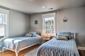 a bedroom with two beds and a window at Walk to Shore: Updated Buzzards Bay Cottage! in Buzzards Bay