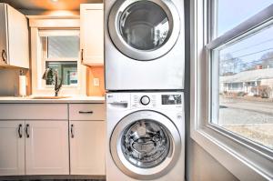 a washing machine in a kitchen with a window at Walk to Shore: Updated Buzzards Bay Cottage! in Buzzards Bay