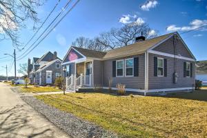 a house on the side of a street at Walk to Shore: Updated Buzzards Bay Cottage! in Buzzards Bay