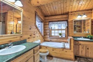 a bathroom with a tub and a toilet and a sink at Piedmont Cabin about 10 Mi to Rapid City! in Piedmont +30 photos