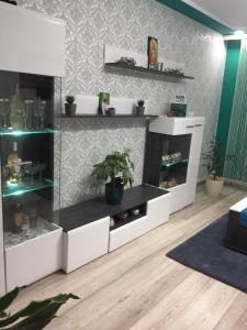 a living room with white shelves and a table at Ca acasa Corbu 2 in Corbu