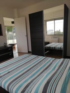 a bedroom with a large bed and a mirror at Résidence Stella Maris in Antibes