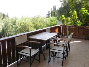 a table and chairs on a balcony with a view at Evridiki's Villas in Agios Nikitas