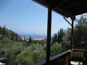 a view of the ocean from the porch of a house at Evridiki's Villas in Agios Nikitas