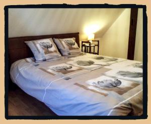 a bed with three pillows on top of it at Résidence des lentilles in Schiltigheim
