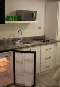 a kitchen with a sink and a refrigerator at Super Precio in Guatemala