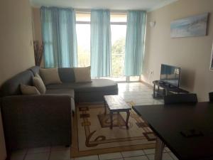 a living room with a couch and a table at Strandburg Holiday Apartments in Amanzimtoti