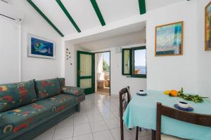 a living room with a couch and a table at Vineyard Cottages - Murvica (146) in Murvica