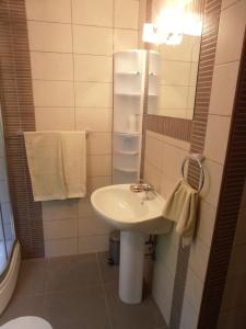 a bathroom with a sink and a mirror and towels at Apartments VESNA (63) in Veli Lošinj