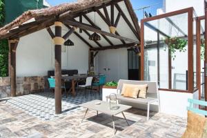 a patio with a white couch and a table at Vientos de Marbella - EaW Homes in Marbella