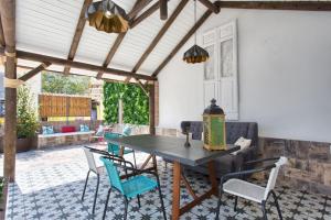 a patio with a wooden table and chairs at Vientos de Marbella in Marbella