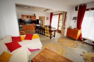 a living room with two beds and a kitchen at Gîte le Rocher - Apartment on the ground floor for 8 people in La Grave