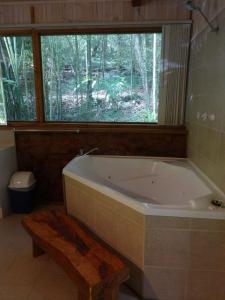 a bath tub sitting next to a toilet in a bathroom at Treetops Montville in Montville