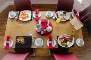 
a table topped with plates of food and drinks at Killaran House in Killarney
