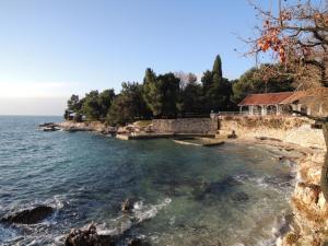 a house on the shore of a body of water at Pool-Apartments Porec (4400) in Poreč