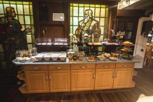 a kitchen with a buffet of food and a stained glass window at Landhotel Villa Foresta Braunlage in Braunlage