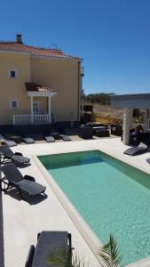 a swimming pool with lounge chairs and a house at Room in Zaton (Zadar) with Wi-Fi, washing machine (4141-8) in Zaton