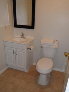 a bathroom with a white toilet and a sink at Franklin Terrace Motel in Seaside Heights