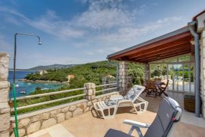 a patio with chairs and a view of the water at House Stivan (4239) in Štivan