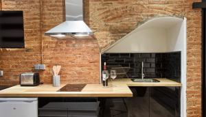 a kitchen with a counter and a brick wall at Vientos de Marbella in Marbella +69 photos