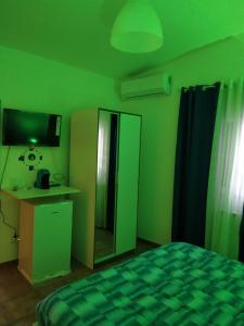 a bedroom with green walls and a bed and a desk at Scibetta's B&B in Taranto