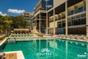 a swimming pool in front of a building at Grand Suítes Family Resort in Itá