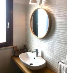 a bathroom with a sink and a mirror on the wall at Terrazza D'Amare in Favignana