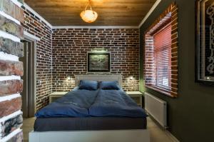 um quarto com uma cama numa parede de tijolos em Hotel Family em Pskov