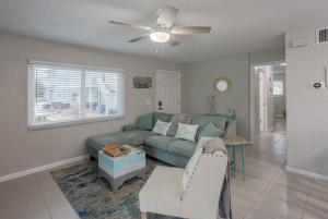a living room with a couch and a ceiling fan at Waterfront & Pool B Star5Vacations in St. Pete Beach