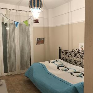 a bedroom with a bed with a blue blanket at Sxinias Resort in Marathón