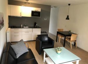 a living room with a couch and a table at Oostzomerland in Mijnsheerenland +21 photos