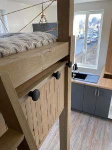 a bed in a tiny house with a window at Studio cocoon in Amboise