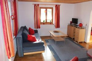 a living room with a couch and a table at Ferienwohnung Brustmann in Teisendorf