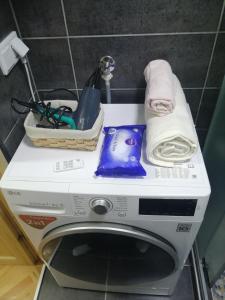 a washing machine sitting on a counter in a bathroom at Small (34m2) modern apartment with parking place in Sarajevo +32 photos