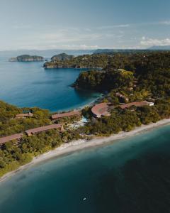 an aerial view of a beach and the ocean at Four Seasons Resort Peninsula Papagayo, Costa Rica in Papagayo, Guanacaste