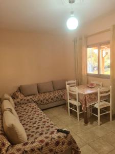 a living room with a couch and a table at Martini Vacation Home in Sarandë +33 photos