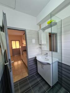 a bathroom with a sink and a mirror at Martini Vacation Home in Sarandë