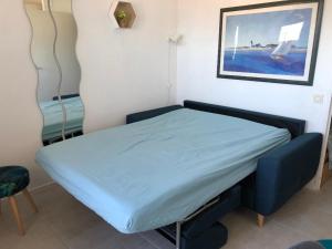 a bed in a room with a blue bed frame at LES CEDRES, Résidence LES OCEANES in Pornichet