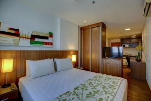 a hotel room with a bed and a television at Nobile Suites Monumental in Brasília
