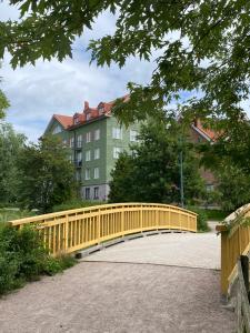 a yellow wooden bridge in front of a building at Garden City Apartment, Helsinki - Vantaa Airport in Vantaa