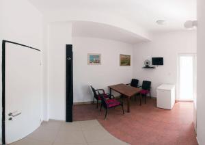 a dining room with a table and chairs at Apartments Rado - close to the sea in Tkon