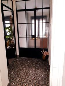 a hallway with a door with a tile floor at Vintage meets Moderne in Koblenz