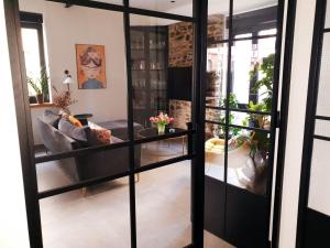a living room with glass doors and a couch at Vintage meets Moderne in Koblenz