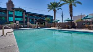 a large swimming pool in a residential area at Best Western Plus Sundial in Scottsdale