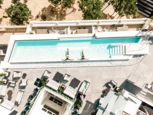 two people are swimming in a swimming pool at HO Puerta de Purchena By Olivencia in Almería +33 photos