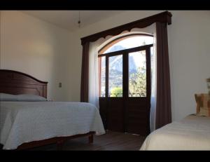 a bedroom with a bed and an open window at Hotel San Diego in Bernal