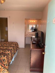 a hotel room with a bed and a person in the mirror at Surfside Motel - Seaside Heights in Seaside Heights