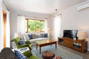 a living room with a couch and a tv at Soloman Street Cottage in Fremantle