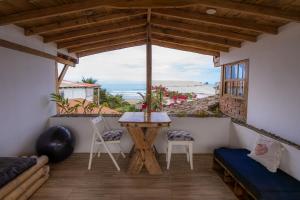 a view from the balcony of a house with a table and chairs at Ganso & Búho in Ayampe